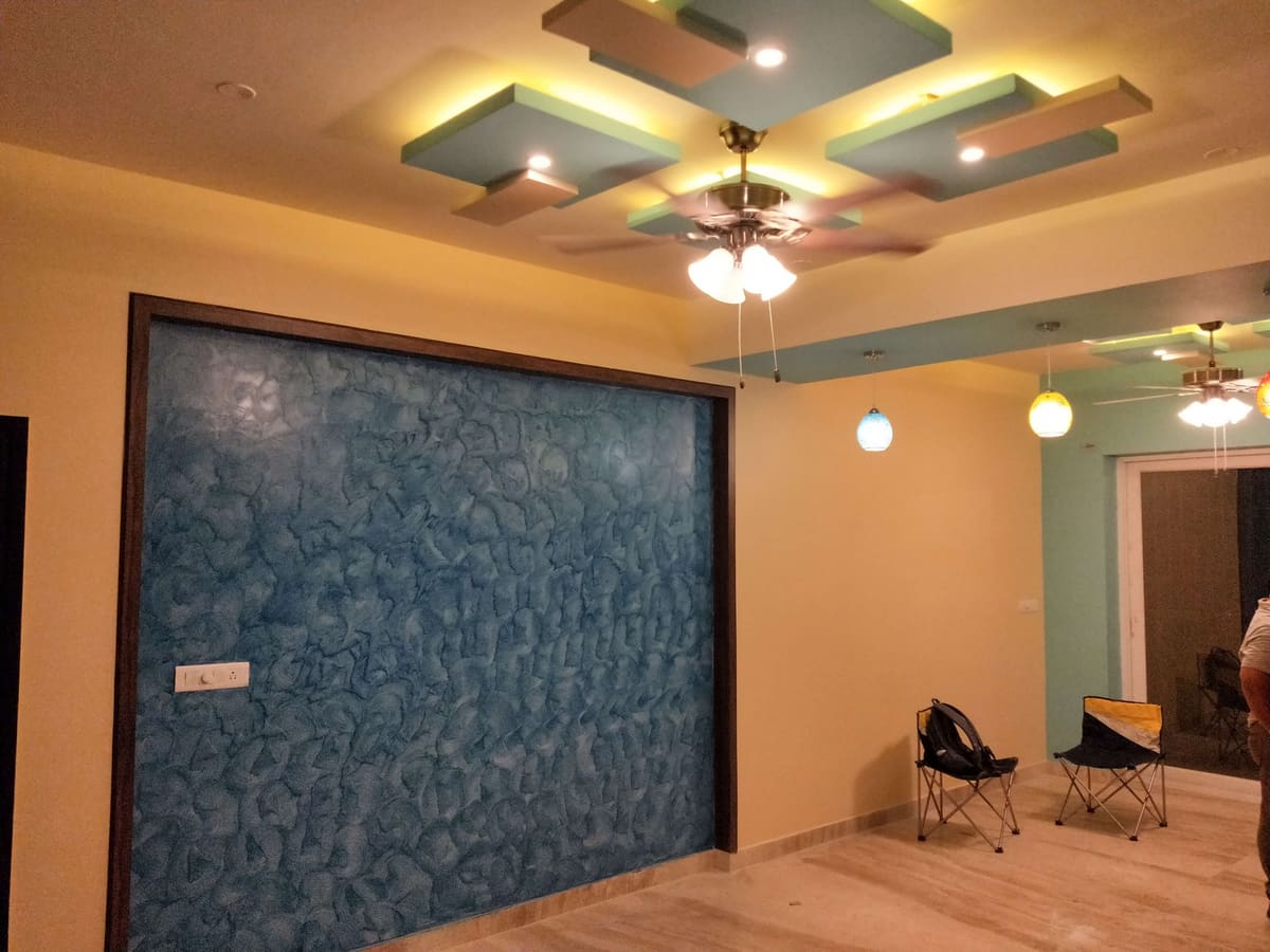 Blue texture feature wall with a lit false ceiling